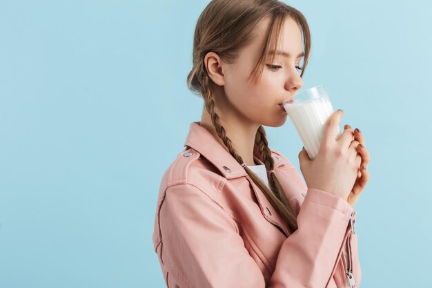 young-attractive-girl-with-two-braids-pink-leather-jacket-dreamily-drinking-milk