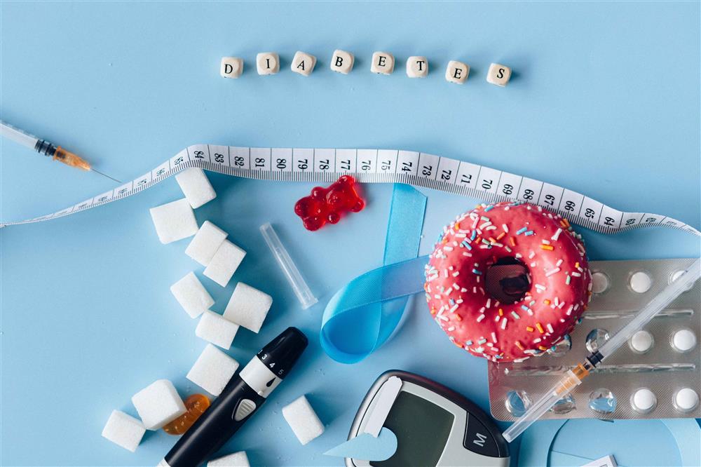 Diabetes-related devices (sugar, donuts, meter, diabetes symbol ribbon, glucometer, insulin syringe)