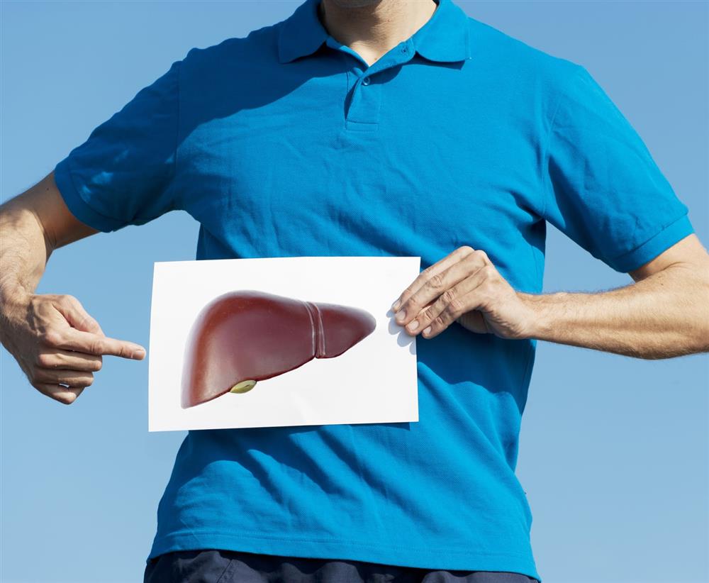 A man pointing to a photo of a liver